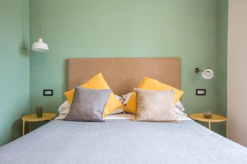 a bedroom with a bed with yellow pillows at SorrentoVibes - Luxury Four Bedroom Home with Amazing Terraces in Sorrento in Sorrento
