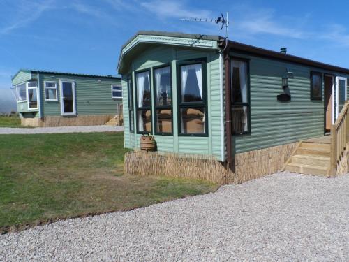 a green tiny house on a gravel road at Peace and quiet in countryside location near Perranporth in Perranzabuloe