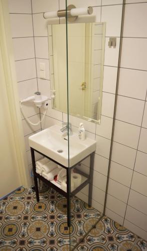 a bathroom with a sink and a mirror at Otepää Apartments in Otepää