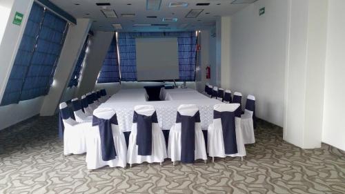 a conference room with a table and chairs in it at Hotel Century Reforma in Mexico City