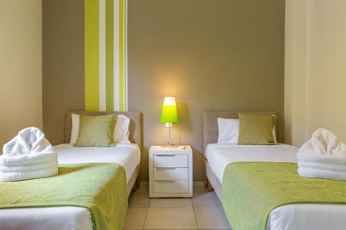 a room with two beds with towels on them at Villas Palm in Le Vauclin