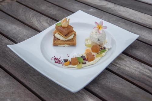 a white plate with some desserts on it at Nayara Hangaroa in Hanga Roa