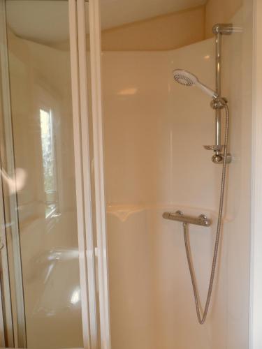a shower with a glass door in a bathroom at Peace and quiet in countryside location near Perranporth in Perranzabuloe