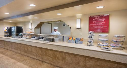 a person behind the counter of a fast food restaurant at Best Western San Dimas Hotel & Suites in San Dimas