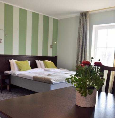 a bedroom with a bed with green and white stripes at Otepää Apartments in Otepää