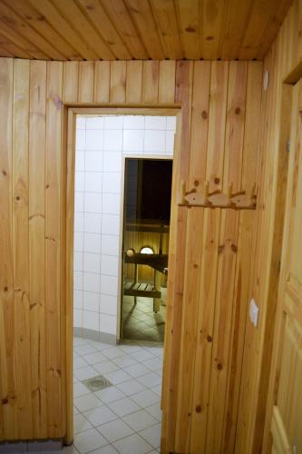 a room with a wooden wall and a doorway at Otepää Apartments in Otepää