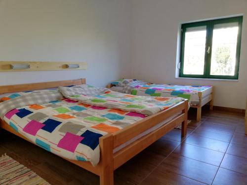 a bedroom with two beds and a window at Kod Male Gospe in Tribunj