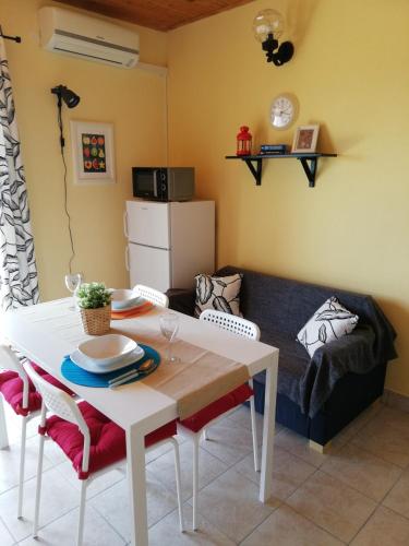 a living room with a table and a couch at Panoramic view studio in Rab