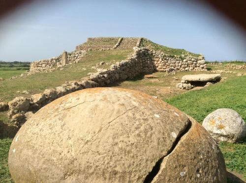 a large rock in front of a pyramid at B&B Luce Viola in Dorgali