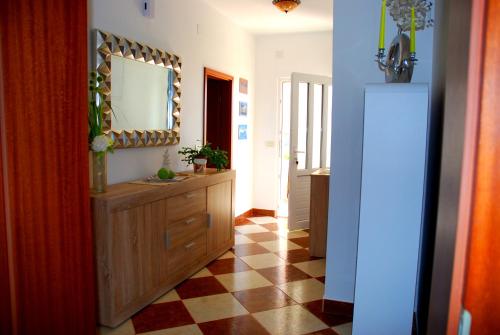 a hallway with a mirror and a checkered floor at Summer Breeze Cavtat in Cavtat