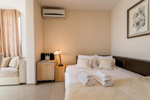 a bedroom with a bed with towels on it at Penthouse View HN in Herceg-Novi