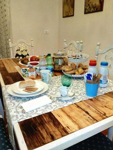 a table topped with plates and bowls of food at Villa dei Pescatori in LʼAquila