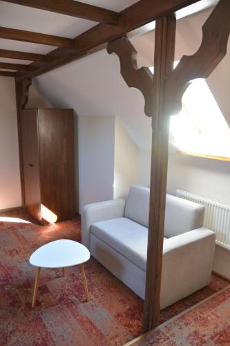 a living room with a couch and a table at Stara Kuźnia Mazurska in Węgorzewo
