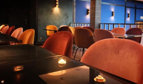 a row of tables and chairs in a room at HANNONG Hotel & Wine Bar in Strasbourg