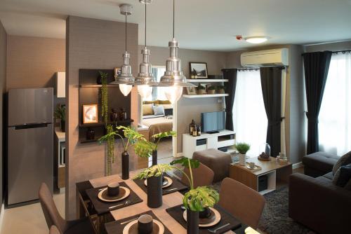 a living room with a table and a dining room at Budget 2 bedrooms Apartment in Huahin in Hua Hin