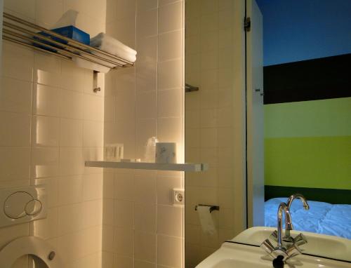 a bathroom with a sink and a toilet and a mirror at LABnul50 Groningen in Groningen