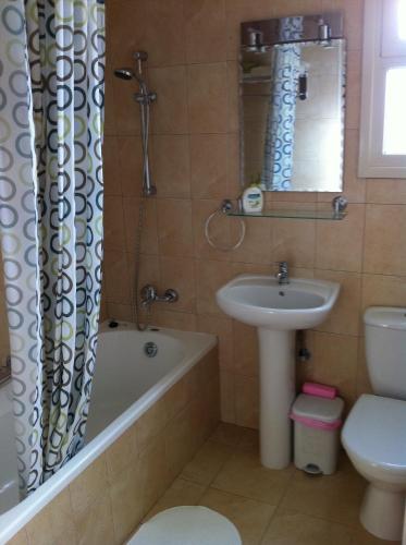 a bathroom with a sink and a tub and a toilet at Sunny Garden Limassol Star - AEMAK-LEM in Limassol