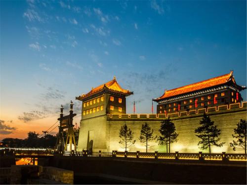 a building with a clock tower next to a bridge at Grand Hyatt Xi'an in Xi'an