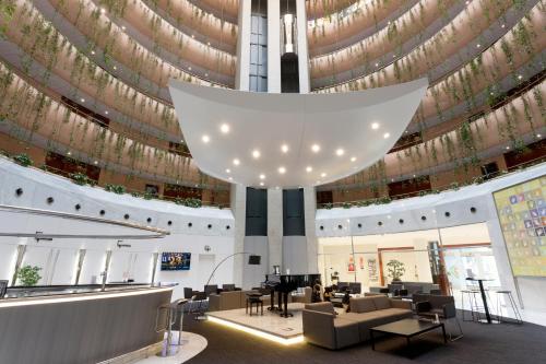 a lobby with a large chandelier in a building at Eurostars Don Cándido in Terrassa