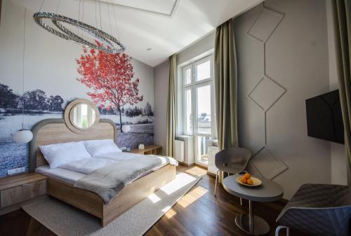 a bedroom with a bed and a large window at Lakeside Budapest Residences in Budapest
