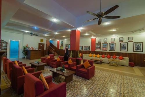 a lobby with couches and tables and a ceiling fan at Mekong Angkor Deluxe Hotel in Siem Reap
