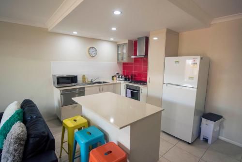 a kitchen with a white refrigerator and a counter at Midland Haven - Midland WA in Midland Junction