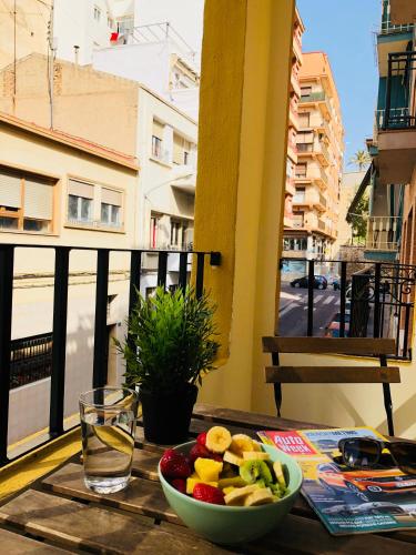 a bowl of fruit on a table on a balcony at White Loft Alicante in Alicante