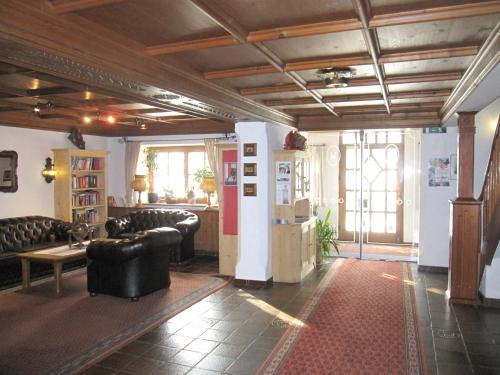 a living room with leather chairs and a table at Gasthof Hotel Doktorwirt in Salzburg