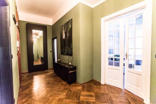 a hallway with a bathroom with a sink and a door at Warsaw Center 110 m2 Spacious and Elegant Apartment in Warsaw