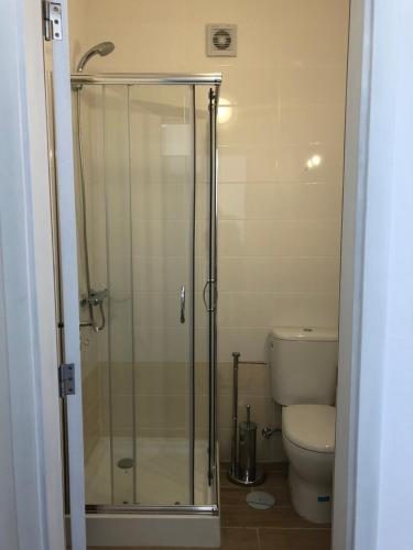 a glass shower in a bathroom with a toilet at Casa da Chã! in Chã