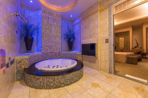 a bathroom with a jacuzzi tub with purple lighting at Hwu Meei Motel in Tainan