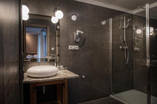 a bathroom with a sink and a shower at Penzión Adrián in Bardejov