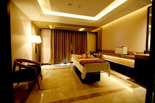 a hotel room with a bed and a chair at Radisson Blu Coimbatore in Coimbatore