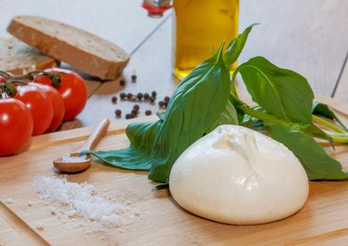 a onion on a cutting board with basil and tomatoes at ibis Marseille Centre Gare Saint Charles in Marseille