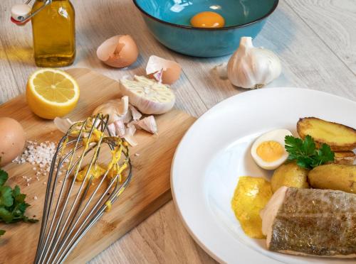 a plate of food with eggs and meat on a cutting board at ibis Marseille Centre Gare Saint Charles in Marseille