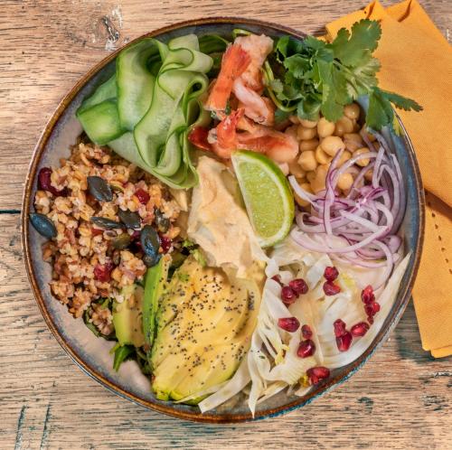 a plate of food on a wooden table at ibis Marseille Centre Gare Saint Charles in Marseille