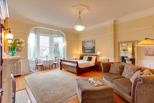 a living room with a couch and a table at Fairholme Manor Inn in Victoria