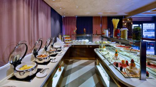 a buffet line with plates of food in a restaurant at Beethoven Premium Hotel in Istanbul