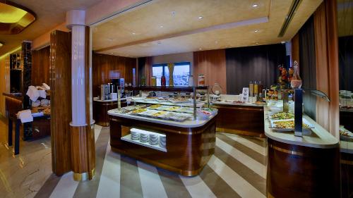 a restaurant with a buffet of food on display at Beethoven Premium Hotel in Istanbul