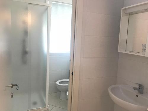 a bathroom with a toilet and a sink at Residence I Diamanti - Siroli Collection in Cervia