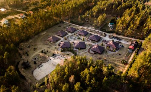 an aerial view of a resort compound with trees at Leśna Oaza in Borek