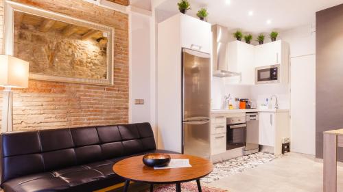 a living room with a couch and a table at Ferreries Boutique Apartment in Girona