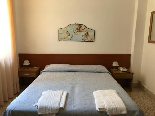 Säng eller sängar i ett rum på Hotel Villa San Giovanni