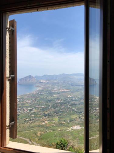 a window with a view of a city and water at Hotel Villa San Giovanni in Erice