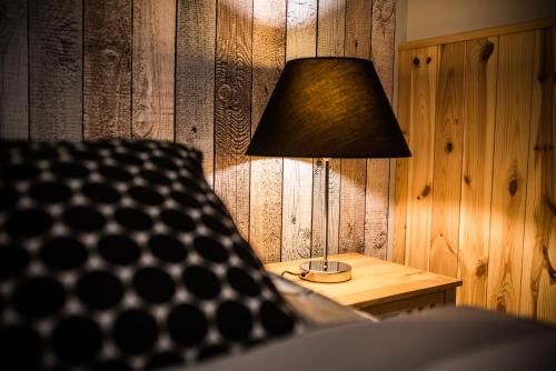 a lamp sitting on a table in a room at Leśna Oaza in Borek