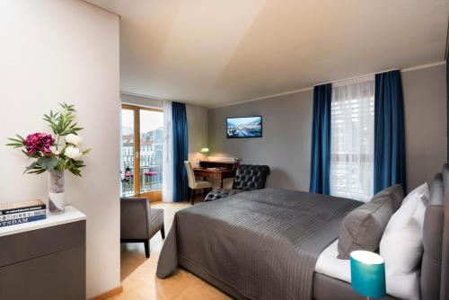 a bedroom with a bed and a desk with a chair at Hotel Ambassador-Berlin Grünau in Berlin