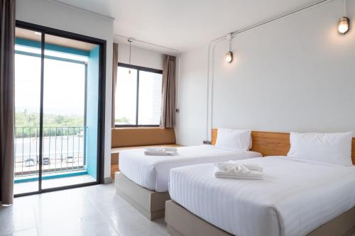 Postel nebo postele na pokoji v ubytování S.22 Hotel Suratthani