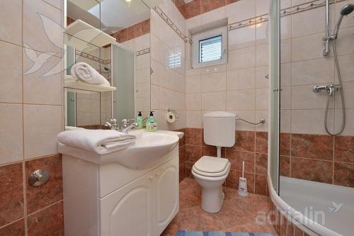 a bathroom with a toilet and a sink and a shower at Mam in Vir
