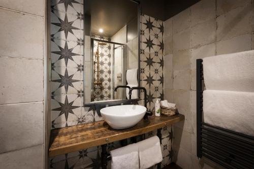 a bathroom with a sink and a mirror at The Bath Hotel in Lynmouth