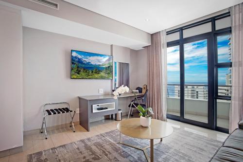 a living room with a desk and a window at The Capital Pearls Hotel in Durban